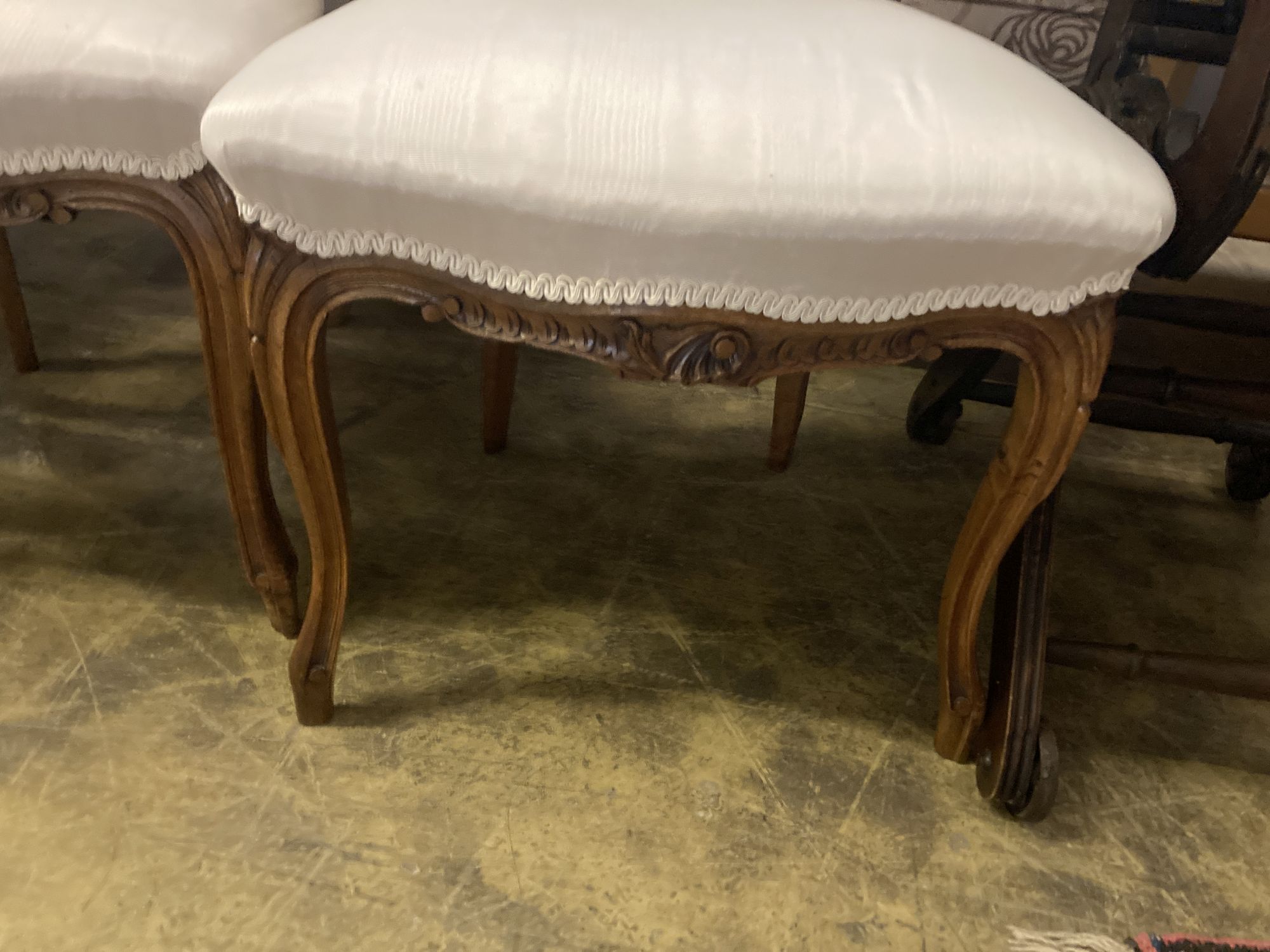 A pair of Louis XV style carved walnut side chairs